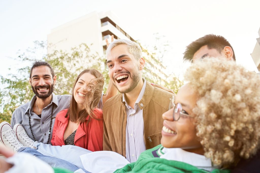 Teenage friends having fun outdoors. Smiling group of people. Happy millennials